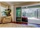 Inviting living room with comfortable seating, natural light, and a view of the pool at 11606 Quiet Forest Dr, Tampa, FL 33635