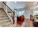 Open-concept living space with staircase, hardwood floors, and natural lighting at 11606 Quiet Forest Dr, Tampa, FL 33635
