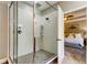 Modern bathroom boasts a glass shower enclosure, white tile, and convenient built-in shelving at 11606 Quiet Forest Dr, Tampa, FL 33635