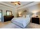 Spacious main bedroom featuring tray ceiling, ceiling fan, carpet flooring and natural light at 11606 Quiet Forest Dr, Tampa, FL 33635