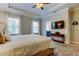 Bright main bedroom featuring plush carpet, tray ceiling, large windows, and ensuite bathroom access at 11606 Quiet Forest Dr, Tampa, FL 33635