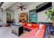 Outdoor patio features a TV, orange seating and a clear view into kitchen at 11606 Quiet Forest Dr, Tampa, FL 33635