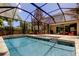 Resort style screened pool with outdoor entertaining and lush landscaping at 11606 Quiet Forest Dr, Tampa, FL 33635