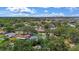 Aerial view of the home nestled in a lush, green neighborhood with mature trees at 11764 Pinedale Ave, Seminole, FL 33772