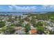 An aerial view of the home in a suburban setting with lush landscaping and nearby waterway at 11764 Pinedale Ave, Seminole, FL 33772