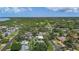 An aerial view highlighting neighborhood of quaint homes nestled among lush greenery and bay at 11764 Pinedale Ave, Seminole, FL 33772