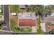 An aerial shot with red shingle roof showcases layout and surrounding neighborhood streets and green spaces at 11764 Pinedale Ave, Seminole, FL 33772