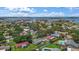 Scenic aerial view of the property surrounded by trees, near a bay and waterfront community at 11764 Pinedale Ave, Seminole, FL 33772