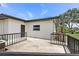 View of back patio featuring a black metal railing and an outdoor area for entertaining and relaxing at 11764 Pinedale Ave, Seminole, FL 33772