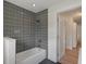 Bathroom featuring a bathtub with gray tile and a shower at 11764 Pinedale Ave, Seminole, FL 33772
