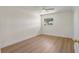 A brightly lit room with new wood look flooring and view of a window at 11764 Pinedale Ave, Seminole, FL 33772