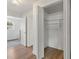 Bright, walk-in closet with ample storage, shelving, and wood-look flooring at 11764 Pinedale Ave, Seminole, FL 33772