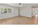Clean living room space featuring light-colored wood flooring and a large window for natural light at 11764 Pinedale Ave, Seminole, FL 33772