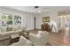 Bright living room with a view of front yard, light-colored wood flooring, and comfortable furnishings at 11764 Pinedale Ave, Seminole, FL 33772