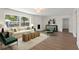 Bright living room featuring modern decor, fireplace, and hardwood floors at 11764 Pinedale Ave, Seminole, FL 33772