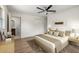 Well-lit main bedroom featuring a ceiling fan, closet, and ensuite bathroom at 11764 Pinedale Ave, Seminole, FL 33772