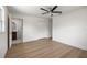 Well-lit main bedroom featuring a ceiling fan, closet, and ensuite bathroom at 11764 Pinedale Ave, Seminole, FL 33772