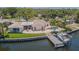 Beautiful waterfront home featuring a pool, dock, outdoor patio, and meticulous landscaping at 1185 36Th Ne Ave, St Petersburg, FL 33704