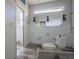 Modern bathroom being renovated with large mirror, new toilet and fresh paint at 1185 36Th Ne Ave, St Petersburg, FL 33704