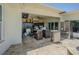 Covered outdoor kitchen featuring a stainless steel refrigerator, stone backsplash, and dining area at 1185 36Th Ne Ave, St Petersburg, FL 33704