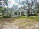Backyard featuring an enclosed pool area and a lush lawn at 12271 Centralia Rd, Weeki Wachee, FL 34614