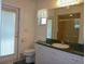 Bathroom with a vanity with marble countertop, white cabinetry, and shower at 12271 Centralia Rd, Weeki Wachee, FL 34614