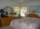 Charming bedroom with a decorative bed, dresser, and a light, airy ambiance at 12271 Centralia Rd, Weeki Wachee, FL 34614