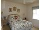 Cozy bedroom featuring a comfortable bed with floral bedding and soft, natural light at 12271 Centralia Rd, Weeki Wachee, FL 34614