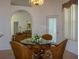 Dining room with a glass-topped table, wicker chairs and views to the living room at 12271 Centralia Rd, Weeki Wachee, FL 34614