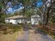 View of the exterior and detached garage of the property, showing the driveway and surroundings at 12271 Centralia Rd, Weeki Wachee, FL 34614
