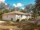 Side exterior of a one-story home, set back from road with mature trees at 12271 Centralia Rd, Weeki Wachee, FL 34614