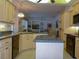 Open kitchen featuring an island, modern appliances, and connection to a cozy living area at 12271 Centralia Rd, Weeki Wachee, FL 34614