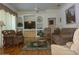 Comfortable living room featuring hardwood floors, plush sofas and a ceiling fan at 12271 Centralia Rd, Weeki Wachee, FL 34614