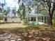 Backyard view of a screened-in pool and lush landscaping surrounding the property at 12271 Centralia Rd, Weeki Wachee, FL 34614