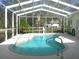 Screened-in pool area featuring a sparkling pool, surrounding patio, and lush landscaping at 12271 Centralia Rd, Weeki Wachee, FL 34614