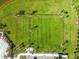 Aerial view of a fenced-in community field with grass, trees, and landscaping at 12517 Nantahala Run, Parrish, FL 34219