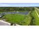 Aerial view of the community features a pond with fountain, green space, and palm trees at 12517 Nantahala Run, Parrish, FL 34219