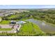 Aerial view of the community pool, clubhouse, and pond with fountain, surrounded by mature trees at 12517 Nantahala Run, Parrish, FL 34219