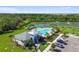 Aerial view of the community pool, clubhouse, pond with fountain, parking, and landscaping at 12517 Nantahala Run, Parrish, FL 34219