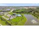 Aerial view of a community featuring a pond with a fountain, a pool and clubhouse at 12517 Nantahala Run, Parrish, FL 34219