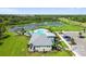 Aerial view of the community pool, clubhouse, well-manicured lawn, and pond with fountain at 12517 Nantahala Run, Parrish, FL 34219