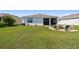 Expansive backyard with a fire pit seating area and partial view of the rear of the house at 12517 Nantahala Run, Parrish, FL 34219