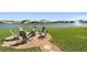 Backyard with lake view, fire pit seating area, and fountain in the background at 12517 Nantahala Run, Parrish, FL 34219