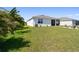Lush backyard featuring green lawn, a seating area around a fire pit, and view of the home at 12517 Nantahala Run, Parrish, FL 34219