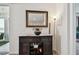 Elegant bar area with decorative mirror, stylish console table, and storage for drinks and bar accessories at 12517 Nantahala Run, Parrish, FL 34219