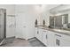Bright bathroom featuring a double vanity with granite countertops, white cabinets, and modern fixtures at 12517 Nantahala Run, Parrish, FL 34219