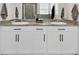 Bright bathroom featuring a double vanity with granite countertops and modern fixtures at 12517 Nantahala Run, Parrish, FL 34219
