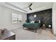 Bedroom with a dramatic geometric accent wall and tray ceiling at 12517 Nantahala Run, Parrish, FL 34219