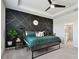 Bedroom with a stylish black accent wall, featuring geometric patterns at 12517 Nantahala Run, Parrish, FL 34219
