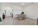 Bright dining area features a wooden table with bench and chairs, tile floor, and entry way at 12517 Nantahala Run, Parrish, FL 34219